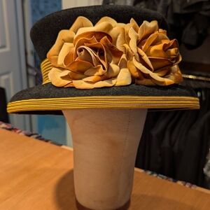 Elegant Black and Gold Floral Hat With Wide Brim And Large Roses.